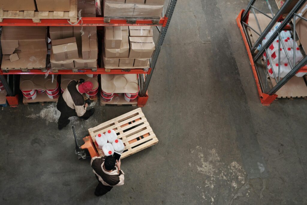 High angle view of workers organizing inventory in a warehouse.